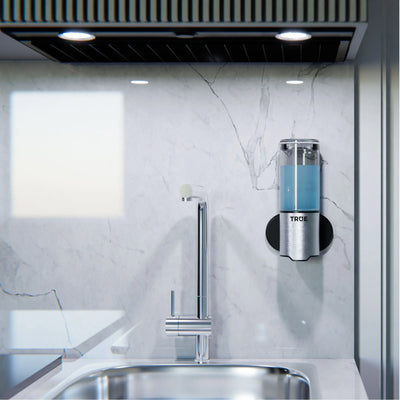 Touchless soap dispenser beside sink